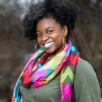 woman in bright scarf smiling at camera