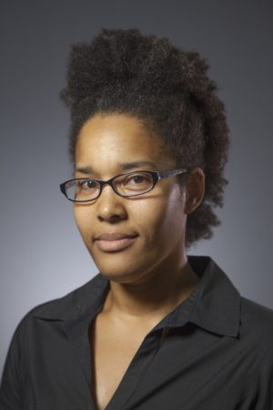 woman wearing black collared shirt and glasses