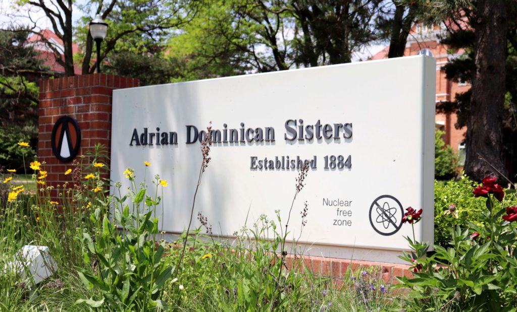 An outdoor sign that reads “Adrian Dominican Sisters, Established 1884.